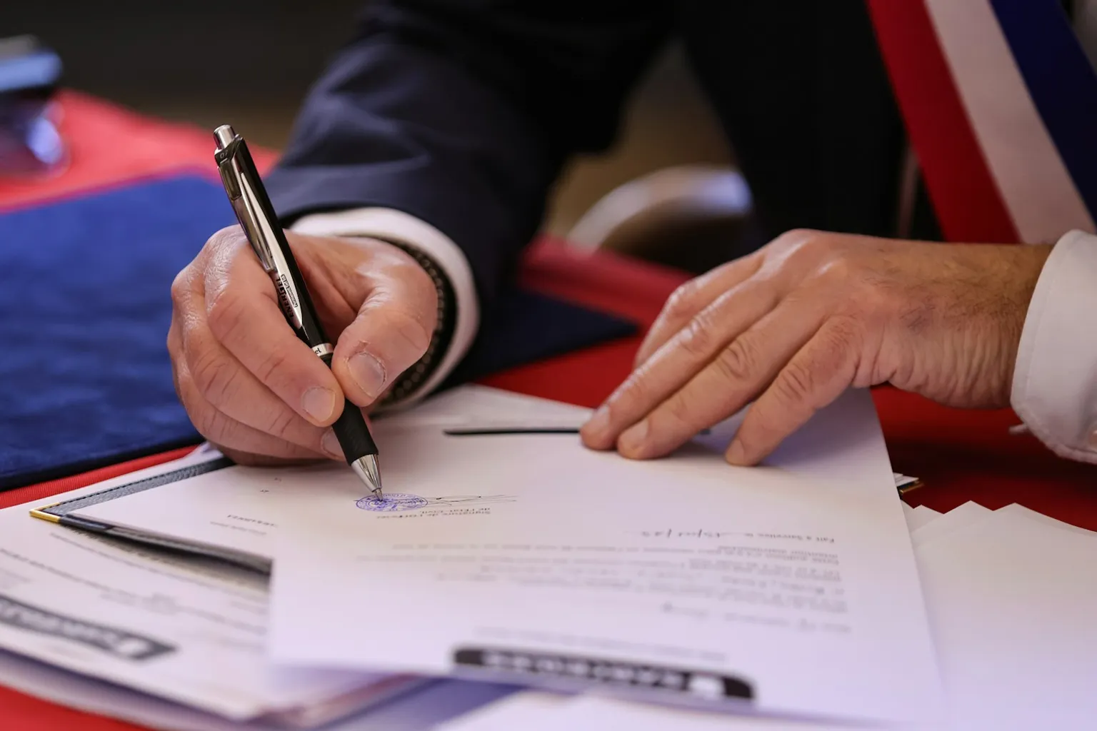 A person signing and stamping a document