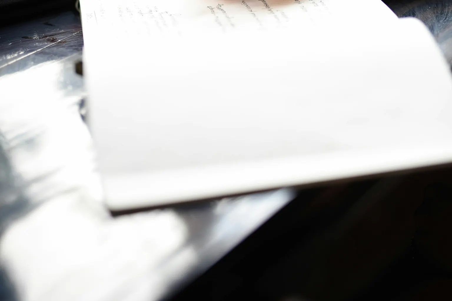 A hand writing a resignation letter on paper